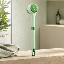 Luma Lather Reach mint electric bath brush on a warm stone bathroom ledge